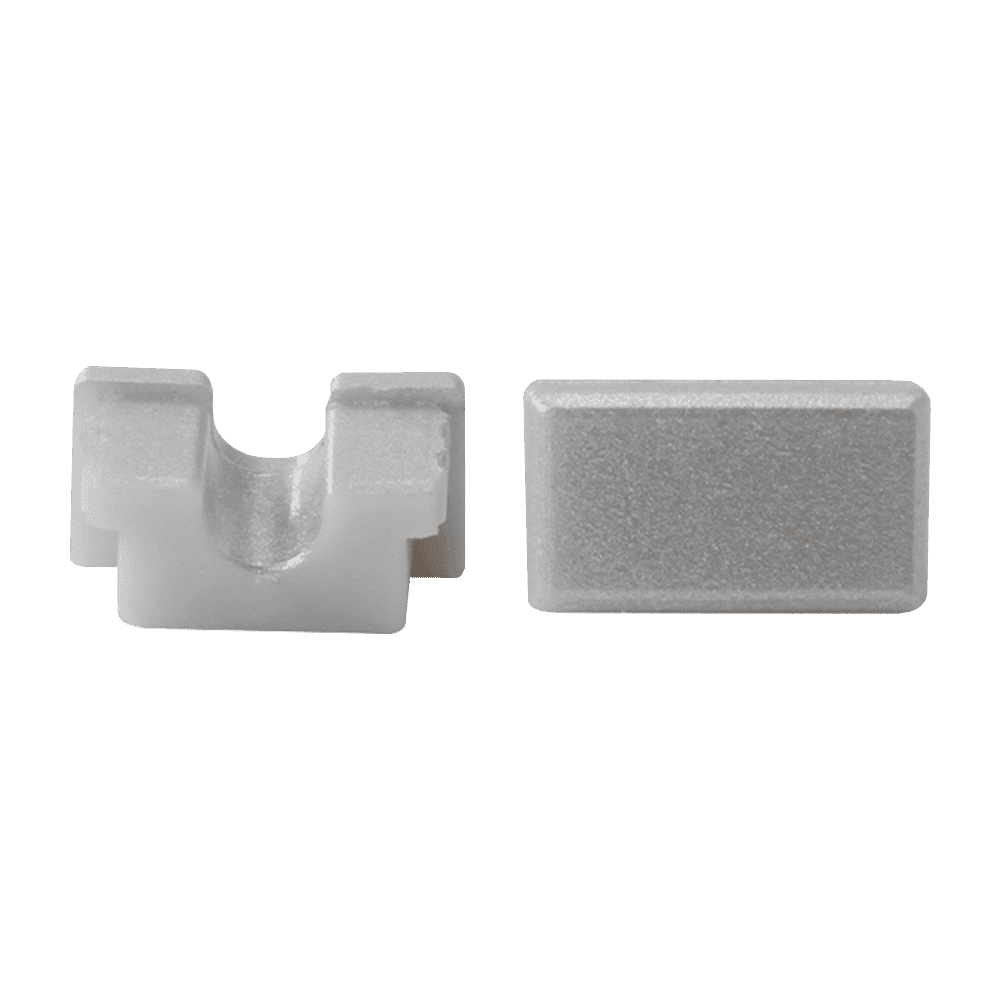 Two white rectangular shaped plastic end caps for aluminum channel rail with one end cap showing a closed design and the other with a hole for LED strip light cable.